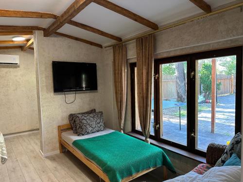 a living room with a bed and a tv at House By The Sea With Hot Tub in Rīga