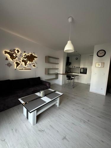 a living room with a couch and a table at Nowe miasto Szczecin in Szczecin