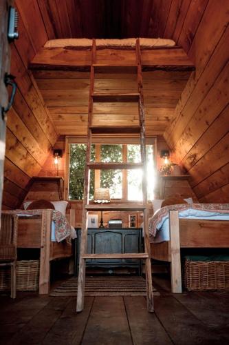 a bedroom with two bunk beds and a window at Pattys Barn Holiday Cottages, Cabins and Venue Hire in Cockerham