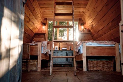 a room with two bunk beds and a window at Pattys Barn Holiday Cottages, Cabins and Venue Hire in Cockerham