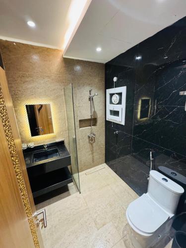 a bathroom with a toilet and a sink and a shower at منتجع صلالة دريم لاند Salalah Dreamland Resort in Salalah