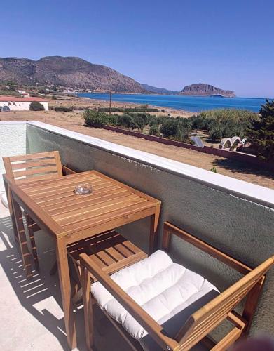 a table and chairs on a balcony with a view of the ocean at Locanda in Monemvasia