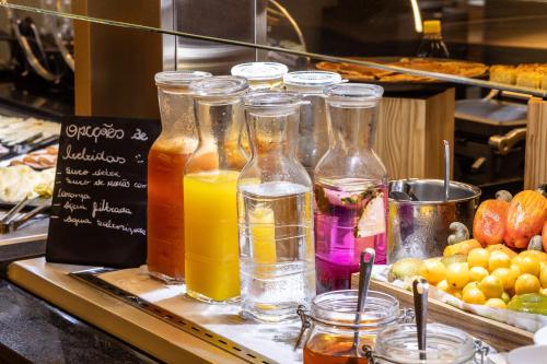 a bunch of different types of drinks in bottles on a counter at ibis Styles Fortaleza Shopping Giga Mall in Fortaleza