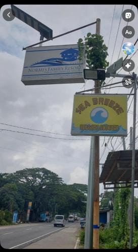 a sign for a restaurant on the side of a road at Seabreeze Beachfront Home and Cottages new management in San Juan