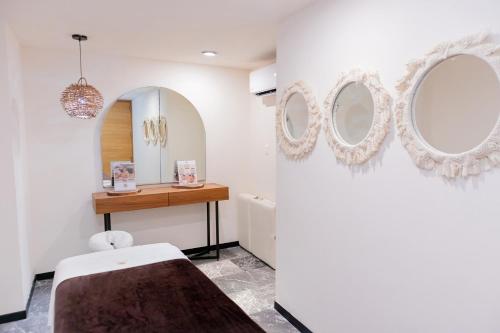 a bathroom with two mirrors on the wall at It Beach Condo in Playa del Carmen