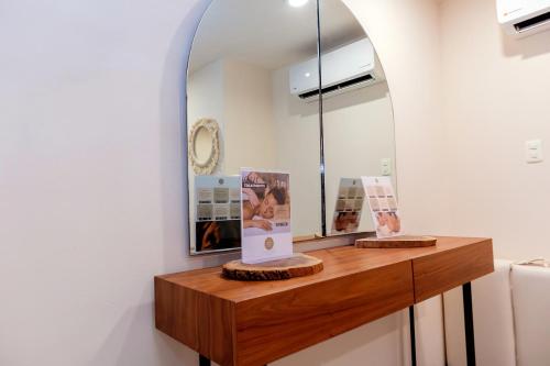 a room with a mirror and a wooden table at It Beach Condo in Playa del Carmen