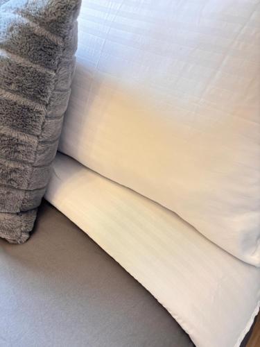 a close up of a pillow on a bed at Casa Lyra Staycation Trees Residences in Manila