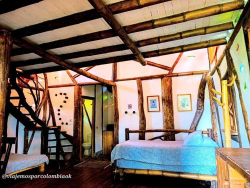 a bedroom with a bed and a wooden ceiling at Hotel La Casa de Francois in San Agustín