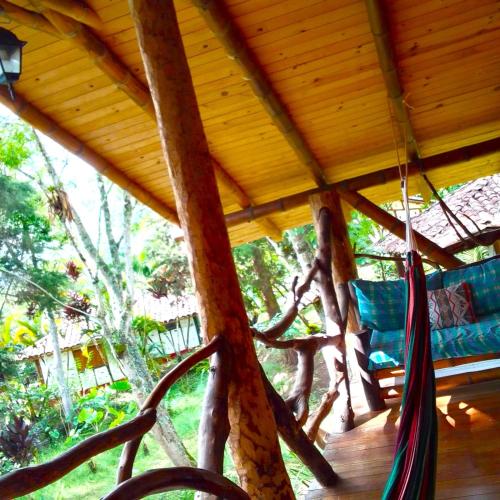 a hammock hanging from a tree in a house at Hotel La Casa de Francois in San Agustín