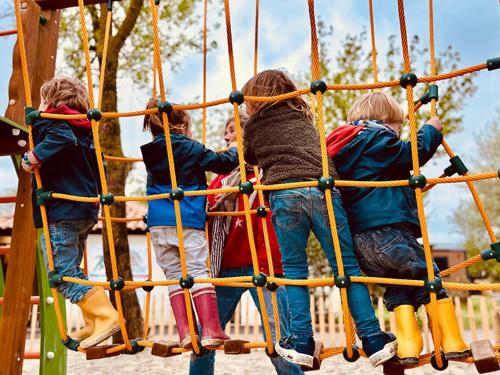a group of children playing on a playground at Camping Le Val de Cesse in Mirepeisset