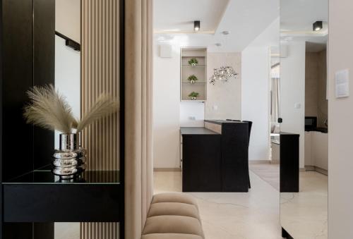 a living room with a black counter and a desk at Crystal Luxury Apartments Rakowicka in Kraków