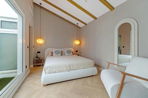 a white bedroom with a bed and a window at Island Paradise in Adeje