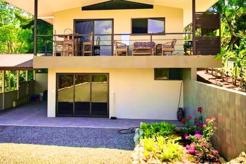 a house with a balcony and a patio at Luxury In The Jungle in Barú