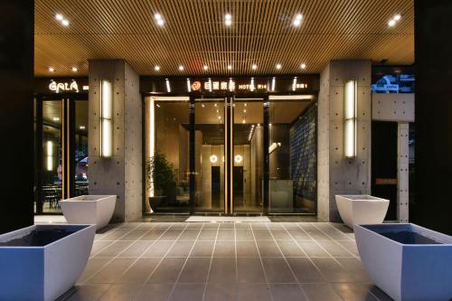 a lobby of a building with a glass door at Hotel R14 in Kaohsiung