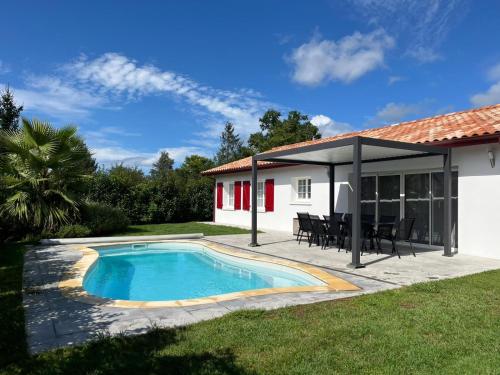 a house with a swimming pool and a patio at Maison "Gure Zerua", Pays Basque in Cambo-les-Bains