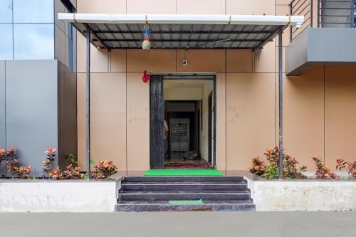 a building with stairs leading to a doorway at Hotel O Avaanti in Pune