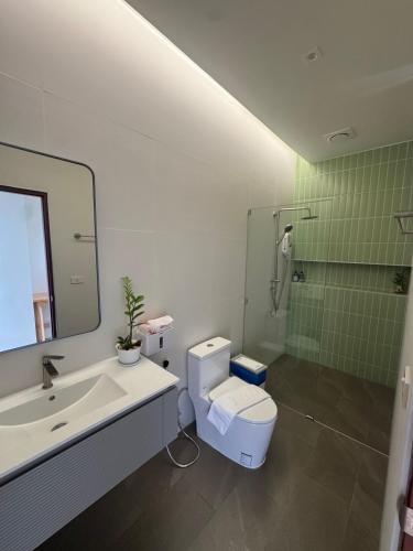 a bathroom with a toilet and a sink and a shower at Paradise Villa - 2BR - Private Pool - Peaceful Garden - 4K SmartTV in Thongsala