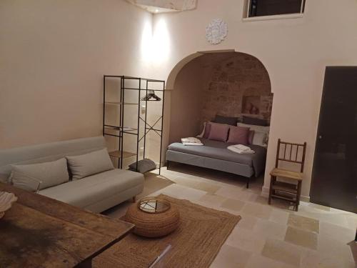 a living room with a couch and a table at interior jacuzzi APT in Ostuni