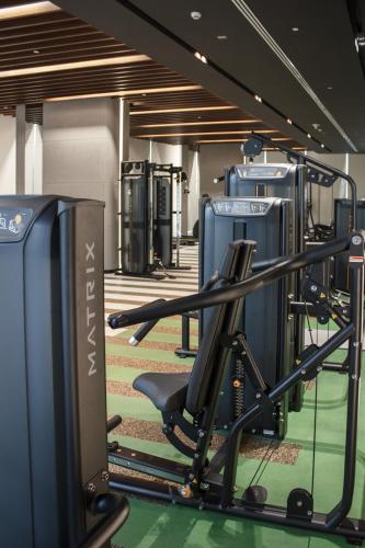 a room with a gym with a treadmill at Velora Stays Cozy Luxury Apartment in Reem Island in Abu Dhabi
