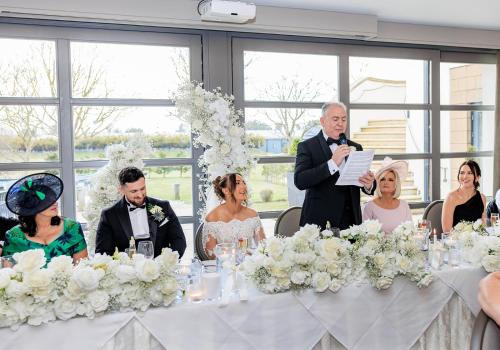 a man giving a speech at a wedding reception at The Gailes Hotel & Spa in Irvine