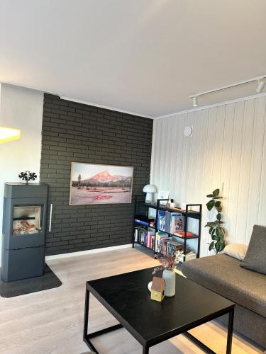 a living room with a couch and a table at Cozy apartment in Tromsø