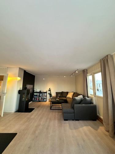 a living room with a couch and a table at Cozy apartment in Tromsø