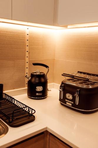 a toaster and toaster sitting on a kitchen counter at Velora Stays Cozy Luxury Apartment in Reem Island in Abu Dhabi