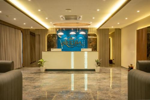 a lobby of a hotel with a sign on the wall at Hotel La Arriba in Ahmedabad