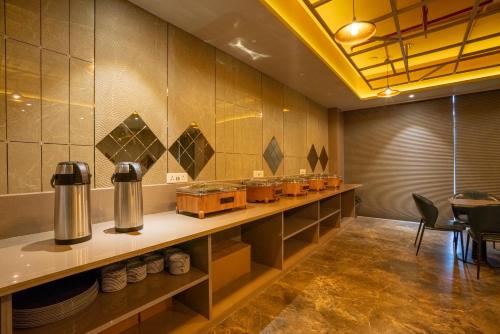 a restaurant with a counter with aasteryasteryasteryasteryasteryasteryasteryasteryastery at Hotel La Arriba in Ahmedabad