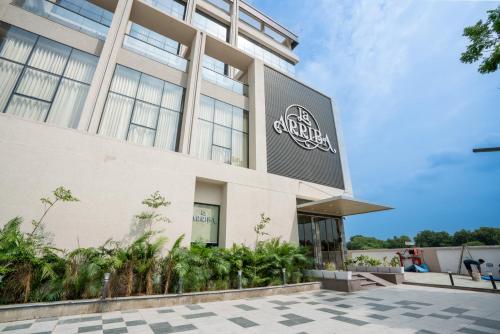 a building with a sign on the side of it at Hotel La Arriba in Ahmedabad