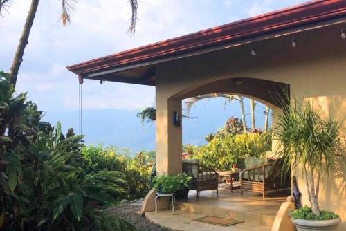 a porch of a house with chairs and plants at Luxury In The Jungle in Barú