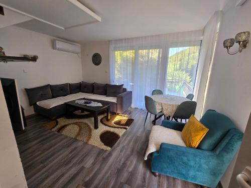a living room with a couch and a table at Weekend house Mila in Bijelo Polje