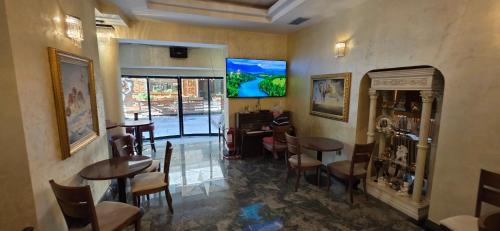 a restaurant with tables and chairs in a room at HOTELS ELSA in Skopje