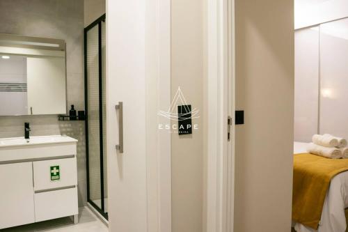 a bathroom with a door leading to a bedroom at Lobos Dream Flat by Escape to Madeira in Câmara de Lobos