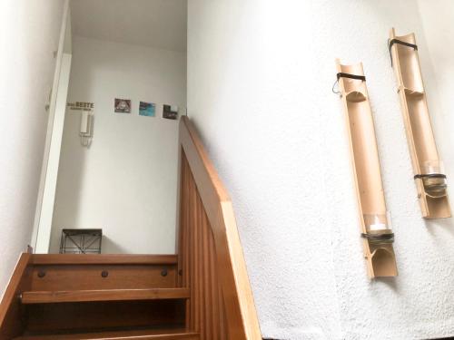 a hallway with a staircase in a building with lights at Moderne Fachwerk-Wohnung im Herzen von Herborn in Herborn
