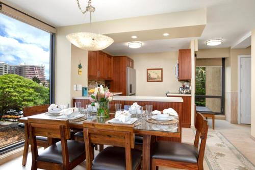 a dining room and kitchen with a table and chairs at Mahana by KBM Resorts in Kaanapali
