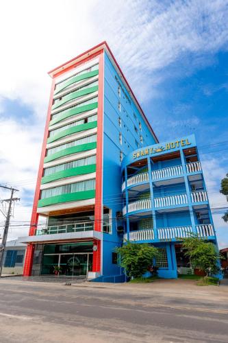 a large blue building with a sign on it at Swamy Hotel in Cruzeiro do Sul