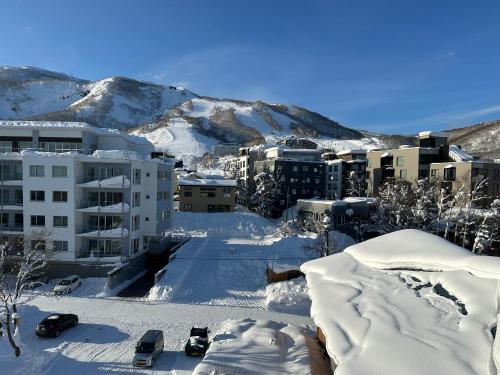 a city covered in snow with mountains in the background at SuiShou in Kutchan