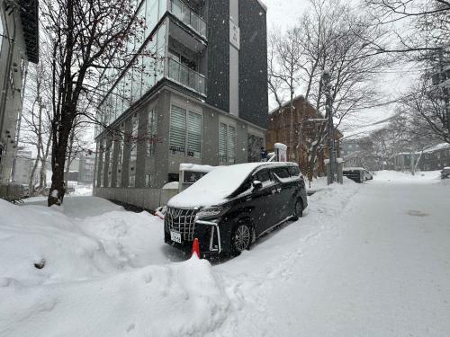a car parked in the snow on a street at SuiShou in Kutchan