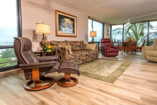 a living room with a couch and a chair at Mahana by KBM Resorts in Kaanapali