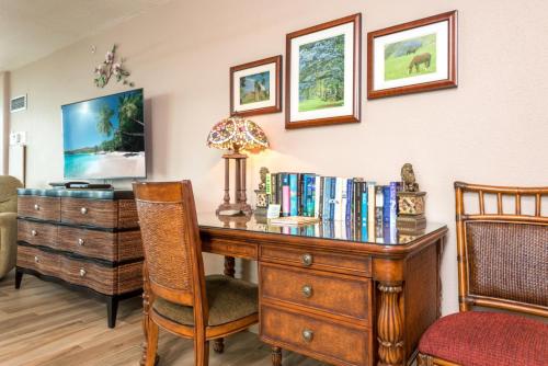 an office with a wooden desk with books at Mahana by KBM Resorts in Kaanapali