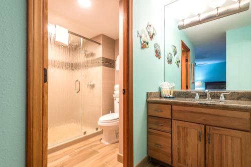 a bathroom with a toilet and a shower and a sink at Mahana by KBM Resorts in Kaanapali