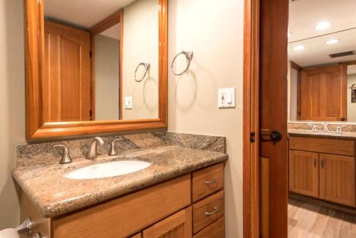 a bathroom with a sink and a mirror at Mahana by KBM Resorts in Kaanapali