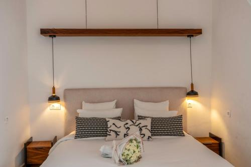 a bed with black and white pillows on it at Maison H Kasbah in Marrakech