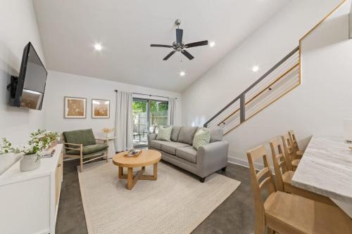 a living room with a couch and a table at Modern King Bed Patio Central Lafayette in Lafayette