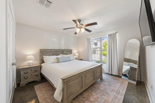 a bedroom with a bed and a ceiling fan at Modern King Bed Patio Central Lafayette in Lafayette