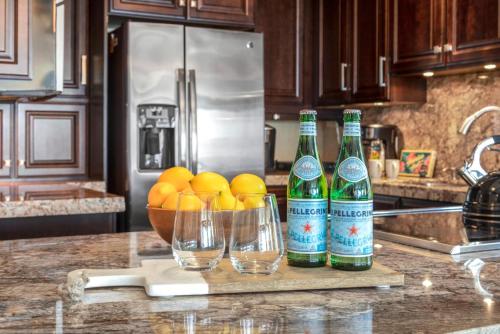 two bottles and glasses on a counter in a kitchen at Mahana by KBM Resorts in Kaanapali