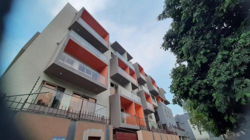 a tall building with orange and white at Palatial Luxury Hotel and Apartment Juba in Juba