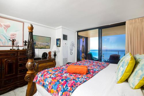 a bedroom with a bed with a view of the ocean at Mahana by KBM Resorts in Kaanapali