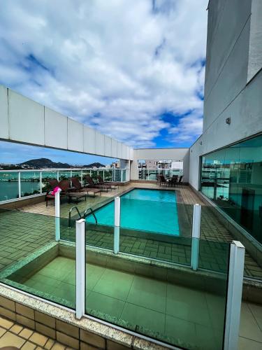 a swimming pool on the roof of a building at Praia do Canto Apart Hotel - Vista para o Mar 102A in Vitória